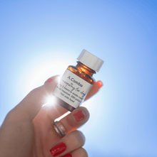 A.Combo Homeopathy for Soothing Joint Support in Dogs bottle held against a blue sky.