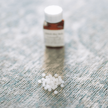 A.Combo Homeopathy for Soothing Joint Support in Dogs on a textured background with white pellets.