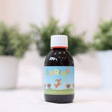 Spring Joint Supplement for Dogs in a bottle on a table, designed to support joints, muscles, and tendons in dogs.