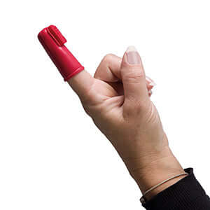 Beaphar finger toothbrush for dogs shown on a finger, ideal for close teeth cleaning and plaque removal.