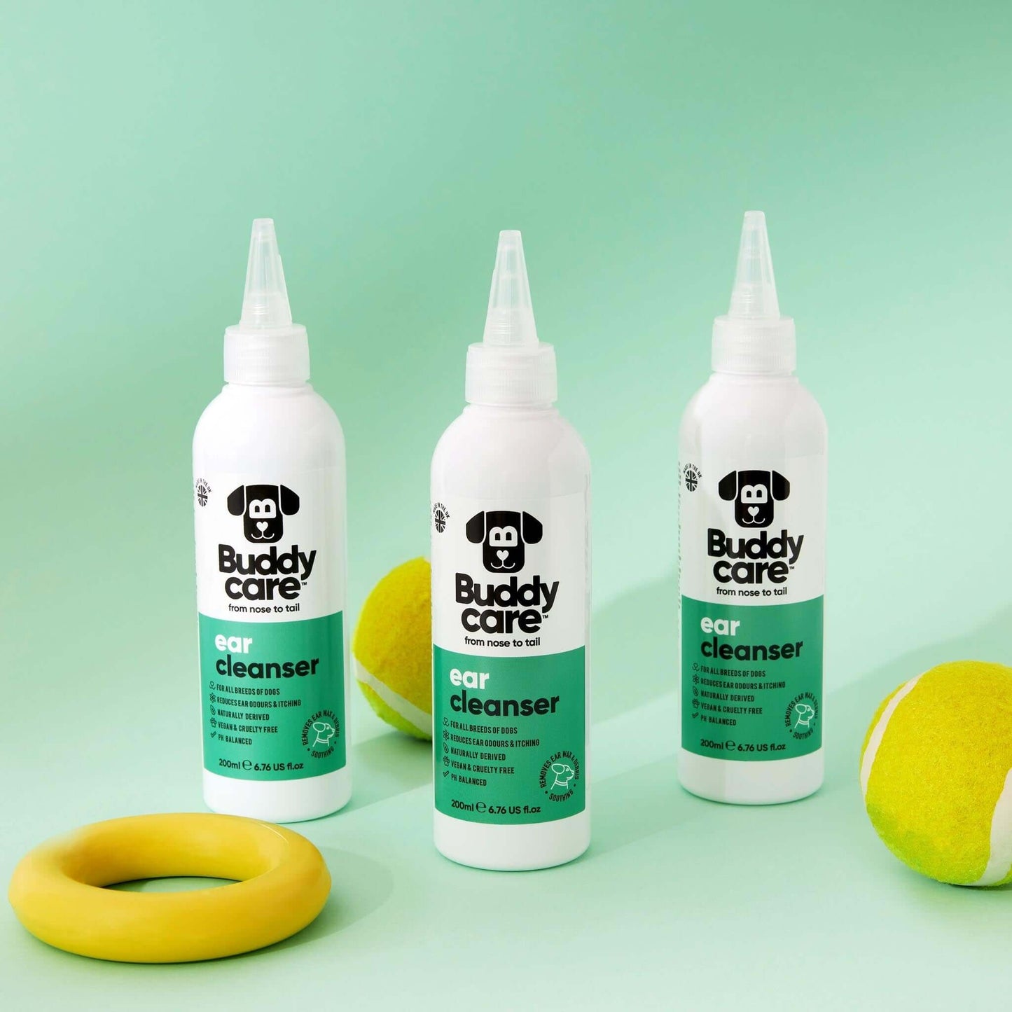 Buddy Ear Cleaner bottles with aloe vera and gentle formula on a green background