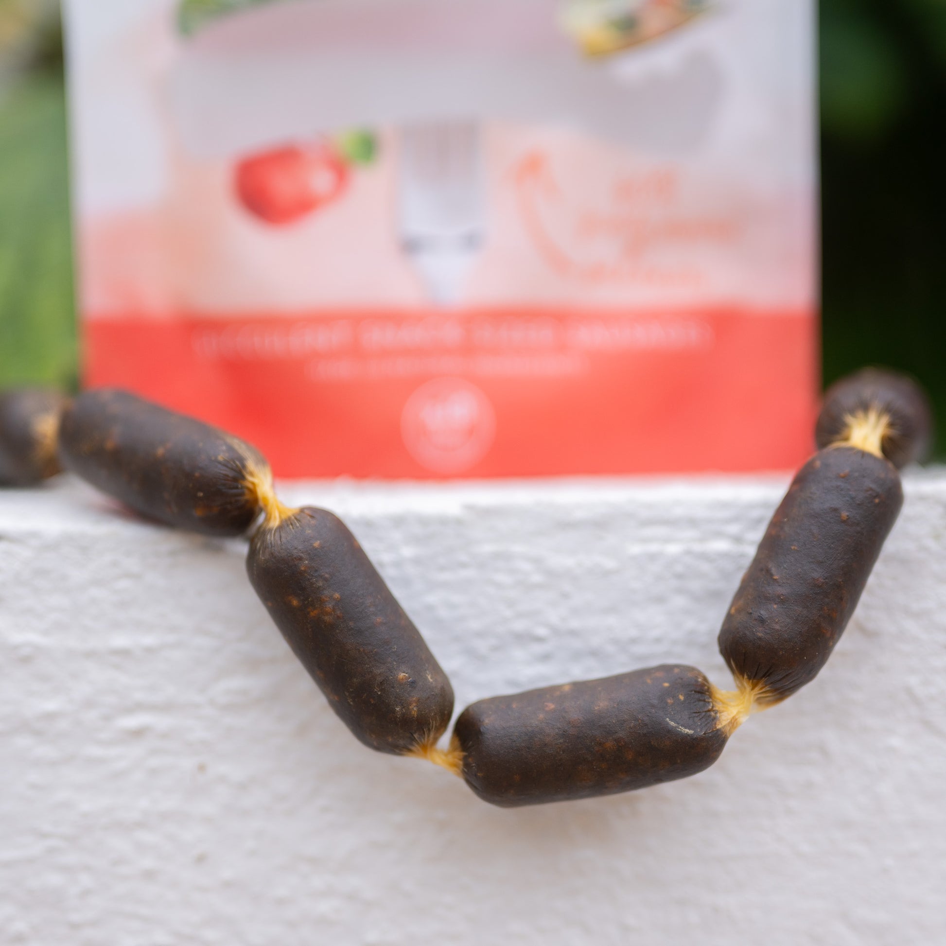 Eden Sausage Treats displayed in a row, showcasing their snack-sized, juicy texture for dogs.