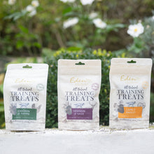 Eden Training Treats packaging for Chicken & Thyme, Venison & Sage, and Lamb & Parsley, displayed outdoors.