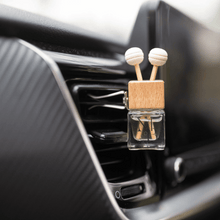 Pet friendly air freshener clipped to air vent of a car