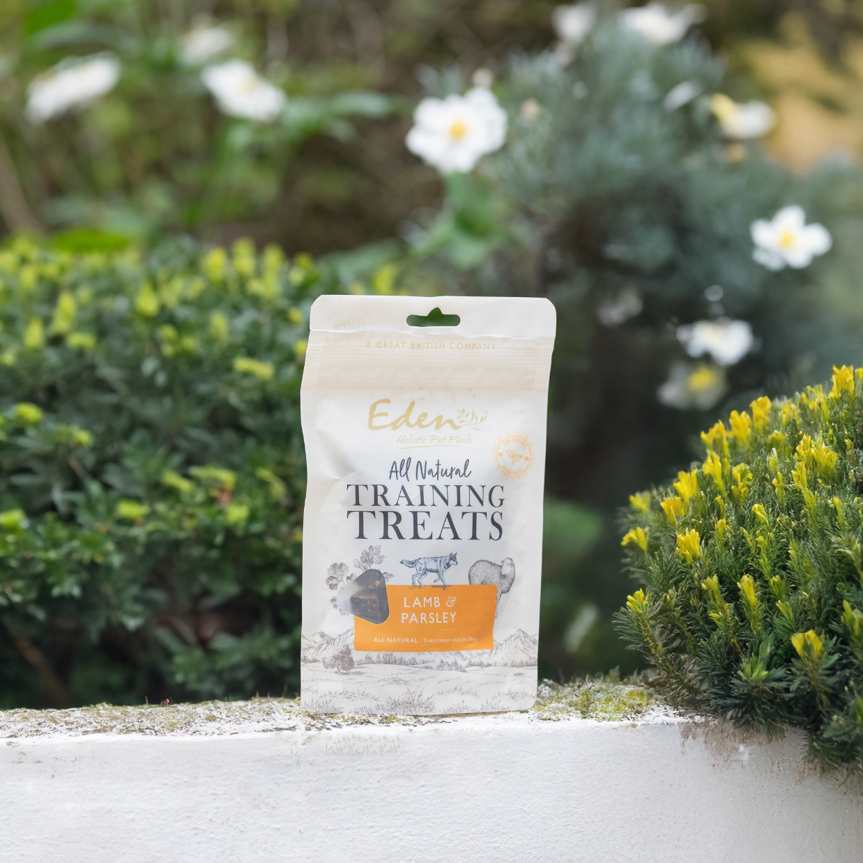 Eden Training Treats package featuring lamb and parsley, displayed among vibrant greenery.