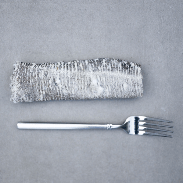 Natural cod skin flatties for dogs with a fork, showcasing a healthy pet treat option.
