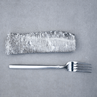 Natural cod skin flatties for dogs with a fork, showcasing a healthy pet treat option.