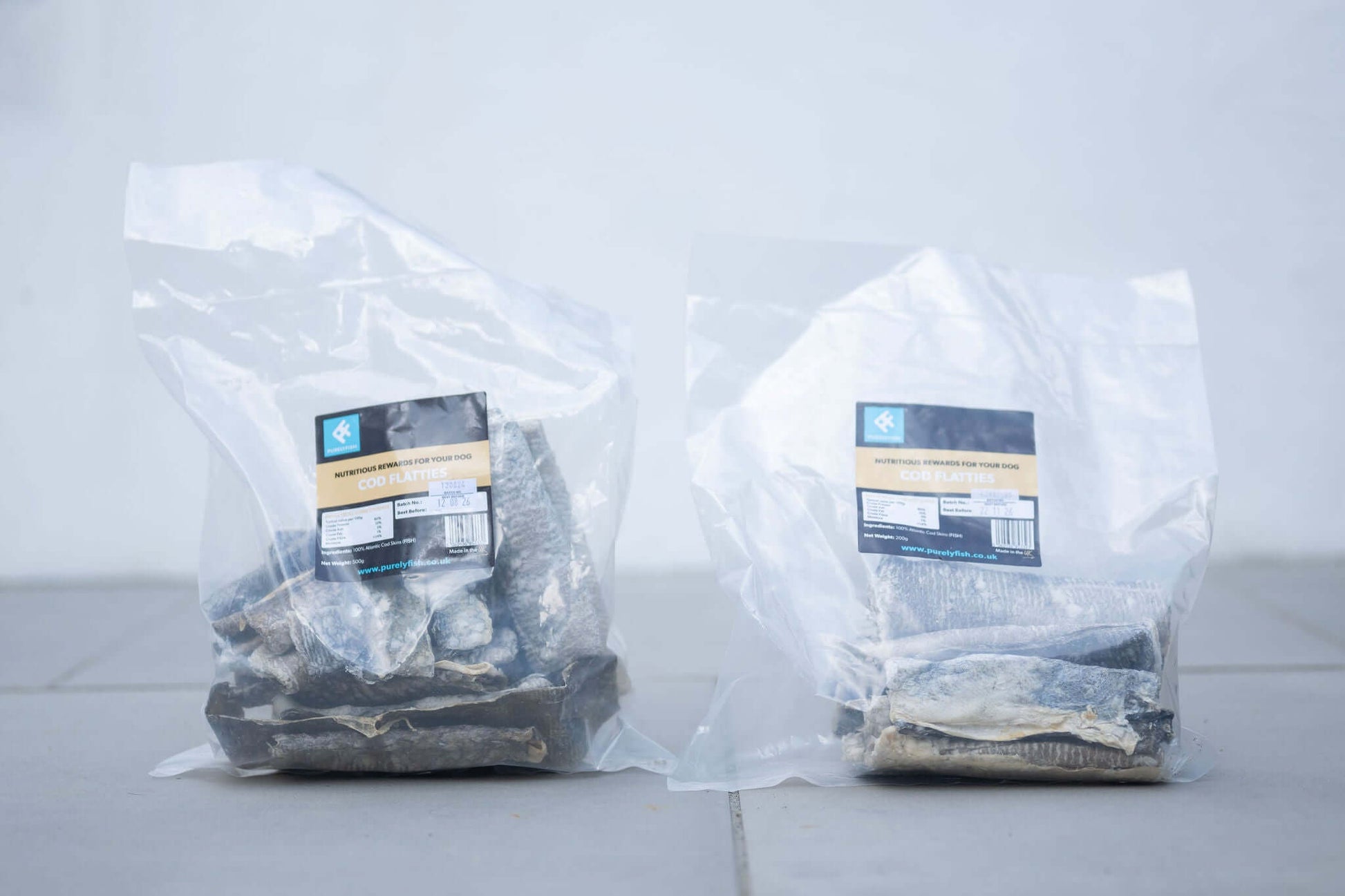 Two clear bags of Cod Skin Flatties for dogs, showcasing healthy, natural dog treats.
